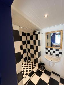 a bathroom with a checkered floor and a sink at The Stables in Protem