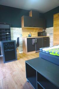 a kitchen with a bed and a table in a room at Apartment Bigler in Osloß