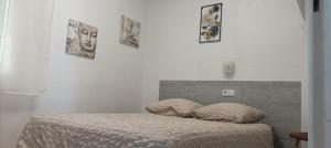 a bedroom with a bed with two pillows on it at Las Delicias ROSES in Roses