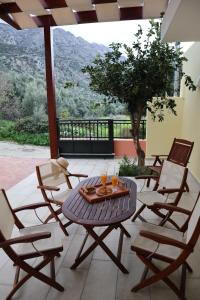 a patio with a table and chairs with a view at Elpida's house in Ierápetra