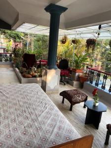 a bedroom with a bed and a porch with plants at Homestay - Heaven Aumgarden in Trivandrum