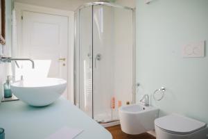 a bathroom with a sink and a toilet and a shower at VillaOmbrosa in Lauria Inferiore