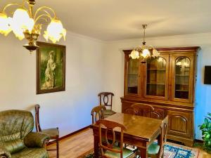 a dining room with a table and a chair at Povoa Center Beach Apartment in Póvoa de Varzim