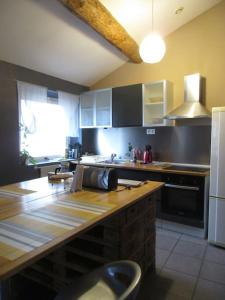 a kitchen with a wooden counter top in a kitchen at Joli/calme et spacieux appartement. in Tarascon