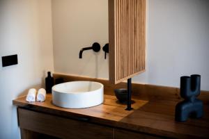 a bathroom with a white sink on a wooden counter at Amaranto Evgatis Limnos in Kondiás +26 photos
