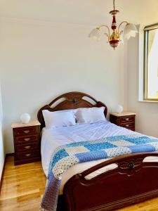 a bedroom with a bed with a quilt on it at Povoa Center Beach Apartment in Póvoa de Varzim