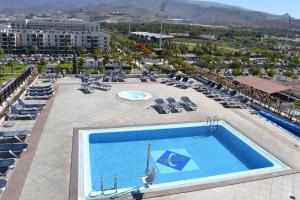 vista sulla piscina con sedie a sdraio di Hotel Zentral Center - Adults only a Playa de las Americas