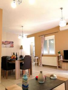 a living room with a table and a dining room at Odyseia Apts I at the center of the City & Old Town in Chania Town +13 photos