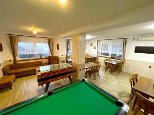 a living room with a pool table and tables at MAXOVO KRÁLOVSTVÍ in Rovensko pod Troskami