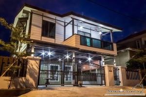 a house lit up at night with lights at Harmonia Homestay in Melaka