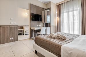 Postel nebo postele na pokoji v ubytování Eracle Hotel
