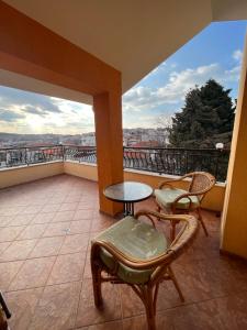 a balcony with chairs and a table and a view at Time out in Sozopol