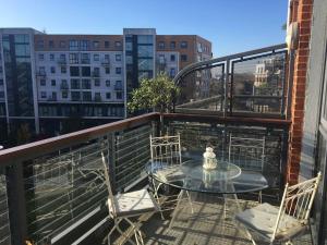 a table and chairs on a balcony with a view at Fantastic New York Style Loft Apartment. in London