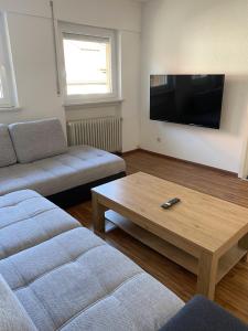 a living room with a couch and a coffee table at Nisas Ferienwohnung in Bad Säckingen