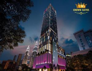 a tall building with a lit up tower in a city at Crown Suites Tropicana The Residence KLCC Bukit Bintang Kuala Lumpur in Kuala Lumpur