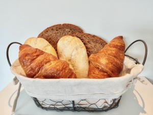 a basket filled with different types of bread at Bed & Breakfast Slaperduin in Buren