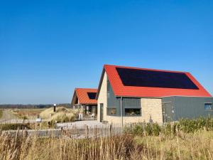 a house with a solar panel on its roof at Bed & Breakfast Slaperduin in Buren