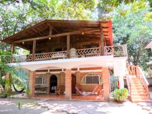 a small building with a balcony on top of it at Casa de Agua EcoHotel in Actopan