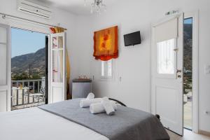 a white bedroom with a bed with towels on it at Villa Frazeska in Kamares +125 photos