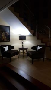 a living room with two chairs and a table at Casa das Oliveiras, o Douro no seu esplendor! in Cinfães