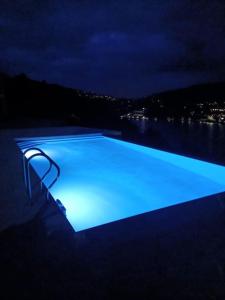 a swimming pool with blue lighting at night at Casa das Oliveiras, o Douro no seu esplendor! in Cinfães
