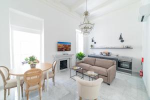 a living room with a couch and a table at Carmelita in Valletta +49 photos