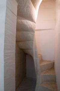 a staircase in a room with white walls at Carmelita Valletta in Valletta