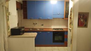 una cucina con armadi blu e lavandino di Sissi House Dolomites a Transacqua