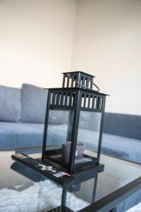 a bird cage sitting on a table in a living room at NSD Home in Antwerp