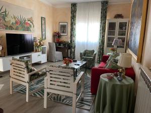 a living room with a couch and a tv at Lovely Versilia Tuscany in Torre del Lago Puccini