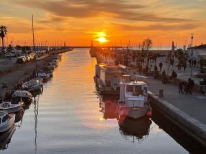 a group of boats docked in a marina at sunset at Lovely Versilia Tuscany in Torre del Lago Puccini