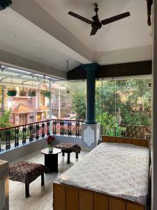 a bedroom with a bed and a large window at Homestay - Heaven Aumgarden in Trivandrum
