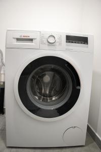 a white washing machine in a room at NSD Home in Antwerp