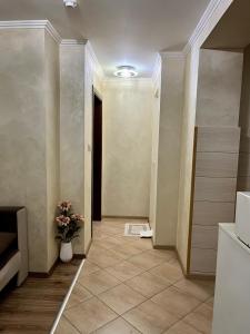 a hallway with a vase of flowers in a room at Hotel Silver in Sozopol