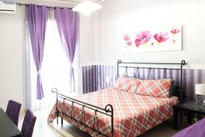 a bedroom with a bed and purple curtains at BEDandFLY in Naples