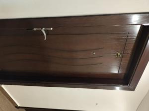 a wooden door with a handle on a wall at Old Street Apartment in Wadi Musa