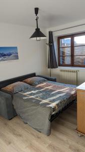 a large bed in a bedroom with a window at Escale du Château de Promery 1391 in Annecy