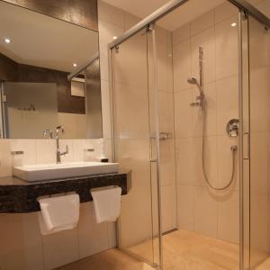 a bathroom with a shower and a sink at Hotel Edelweiß-Schlössl in Kappl