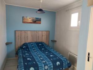 a bedroom with a bed with a wooden headboard at Les Pieds Dans L'eau Accés direct à la plage in La Cotinière +31 photos