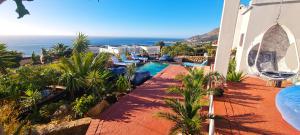 a view of a resort with a swimming pool and the ocean at Beachwood Camps Bay in Cape Town