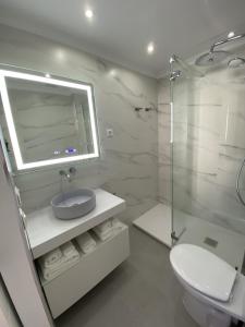 a white bathroom with a sink and a shower at Acapulco playa Nerja 407 planta superior in Nerja