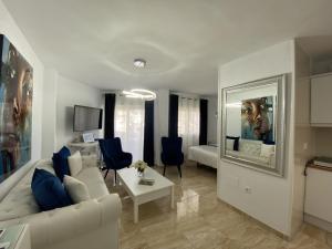 a living room with a white couch and a table at Acapulco playa Nerja 407 planta superior in Nerja