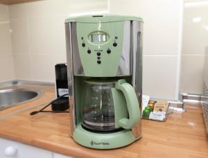 a green coffee maker sitting on a kitchen counter at Acapulco playa Nerja 407 planta superior in Nerja