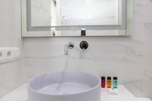 a white bathroom with a sink and a mirror at Acapulco playa Nerja 407 planta superior in Nerja