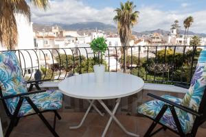 a white table and two chairs on a balcony at Acapulco playa Nerja 407 planta superior in Nerja