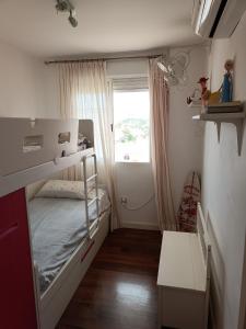 a small room with a bunk bed and a window at 2 Rooms Vistas al Mar Piscina in Cabo de Palos