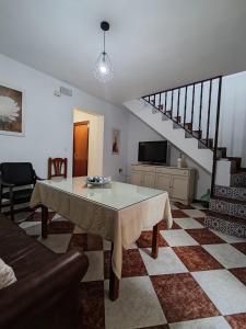 a living room with a table and a staircase at Casa Fregenal Centro R&S in Fregenal de la Sierra