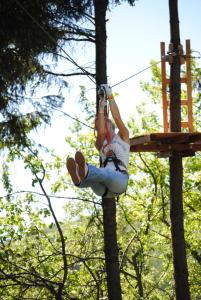 a woman is hanging from a tree at Activ Parc in Negreşti