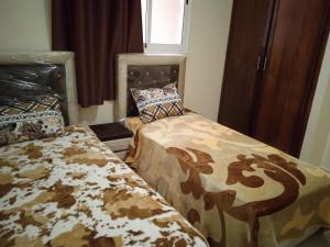 a bedroom with a bed and a bedspread with a horse at Appartement à louer Tiznit 2 in Tiznit