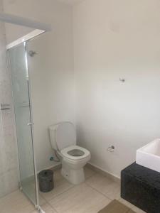 a bathroom with a toilet and a sink at VILLAGE Host Hotel in Pedra Bela